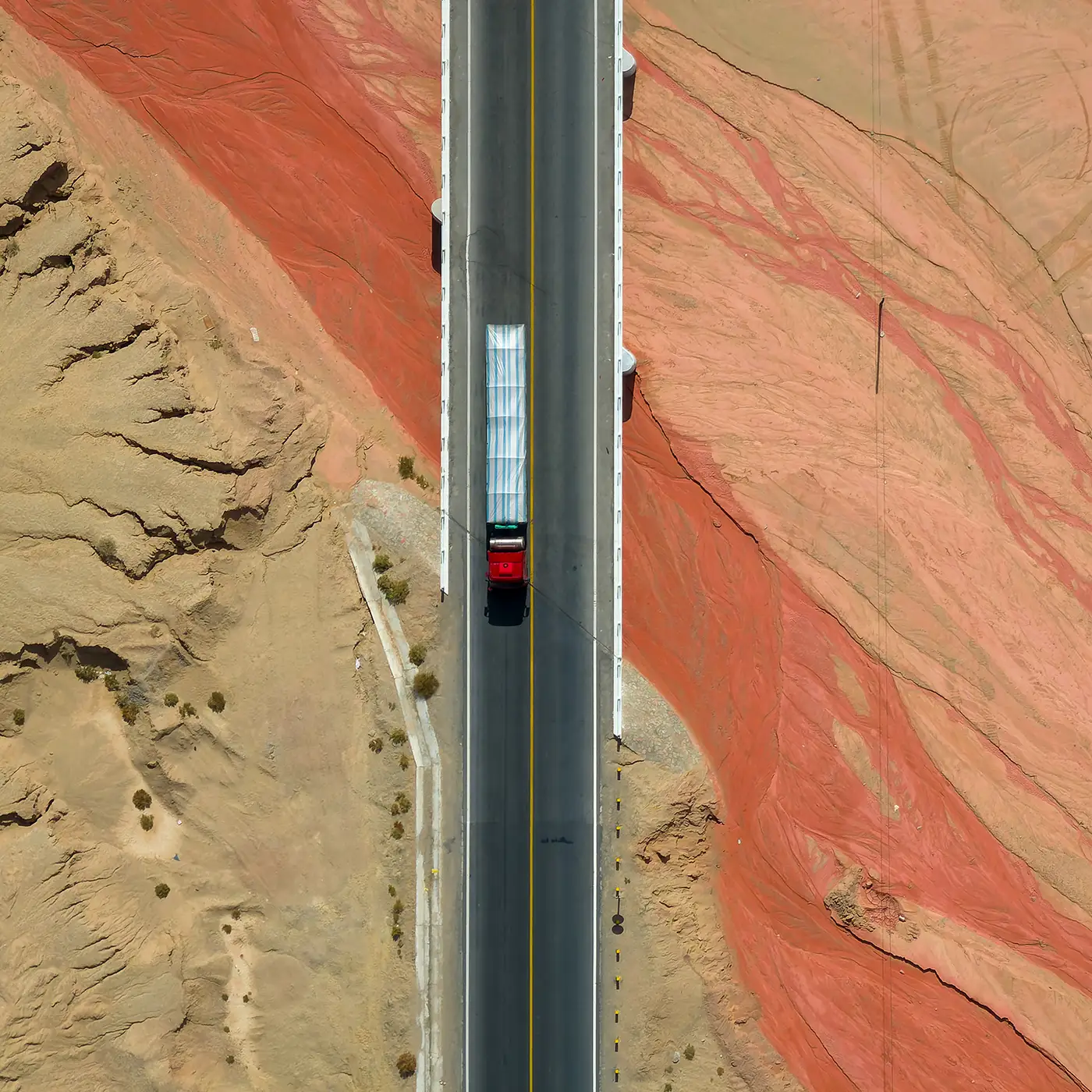Photo of highway over red sandstone landforms